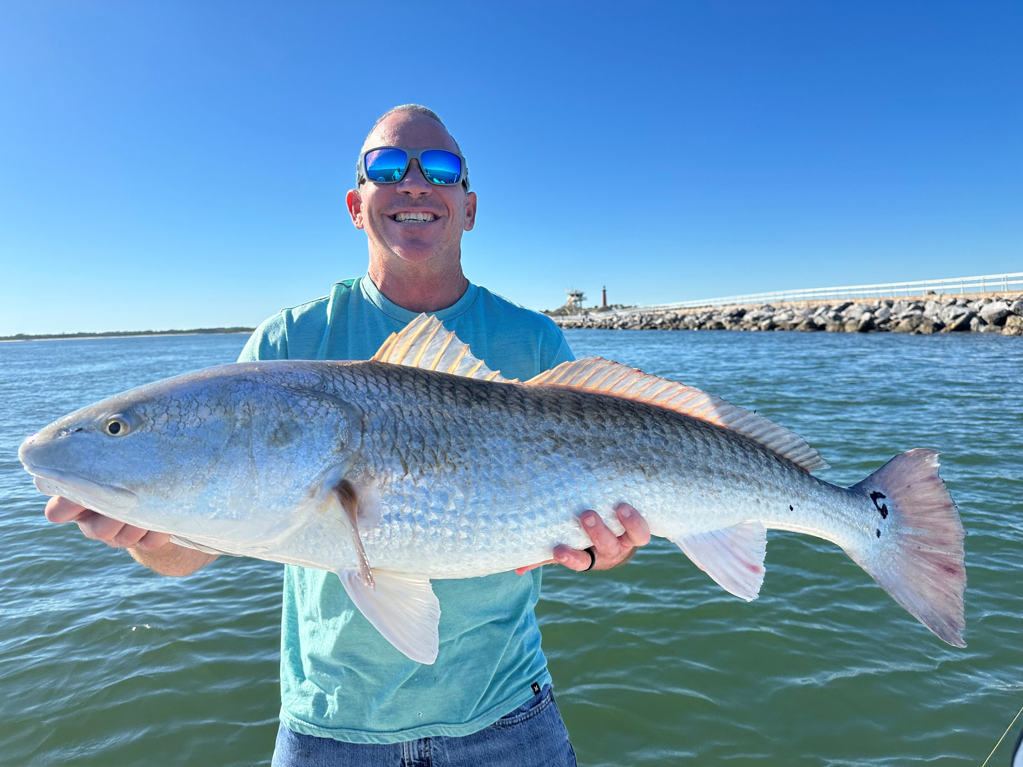 Oak Hill Florida fishing report featuring a redfish catch on the water